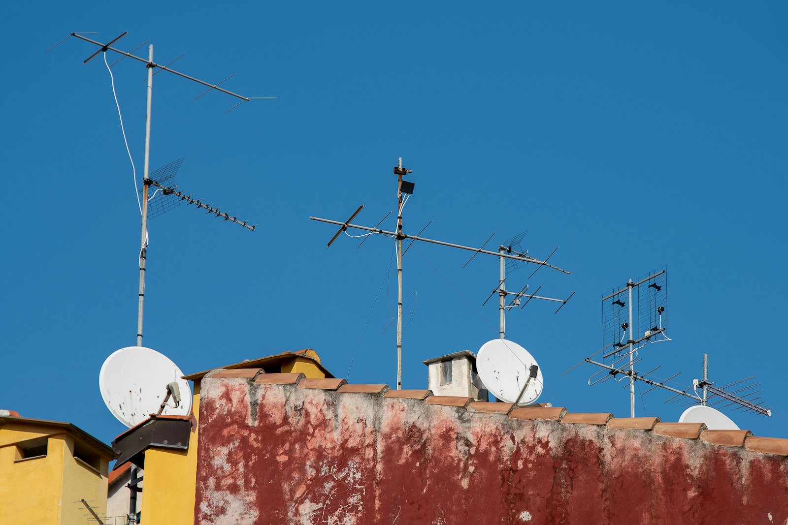 Rooftop satellite dishes receiving broadcast services